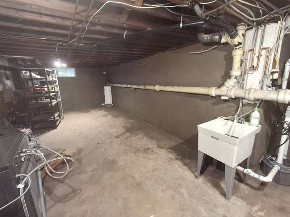 Basement with evenly resurfaced gray walls