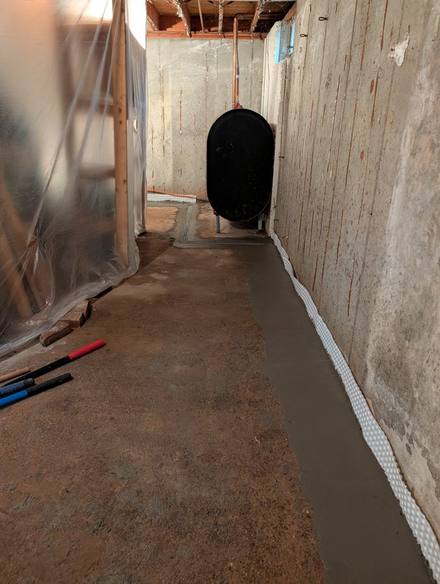 New concrete strip along a basement wall