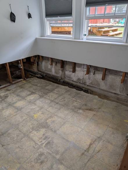 Finished basement room with the lower drywall cut away