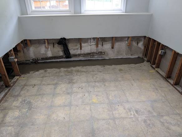 Same room with new concrete along the base of the walls