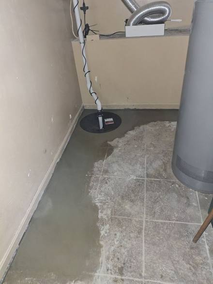 New sump basin in the corner with fresh concrete around it