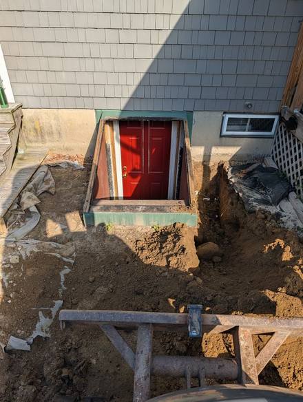 Dug-out basement entry around a red door