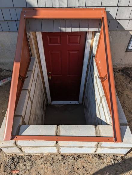 New block walls and a steel frame around the basement door