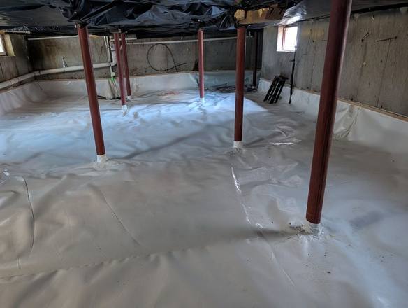 The same space covered with a white liner across the floor and up the base of the walls
